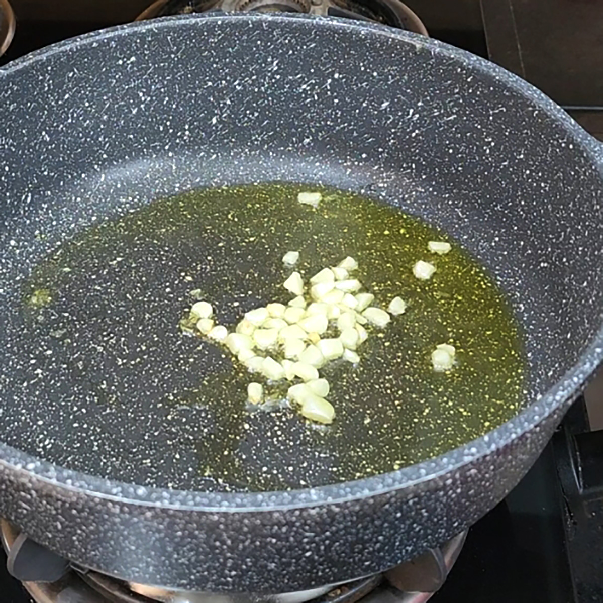 Add olive oil and garlic to the pan. 
