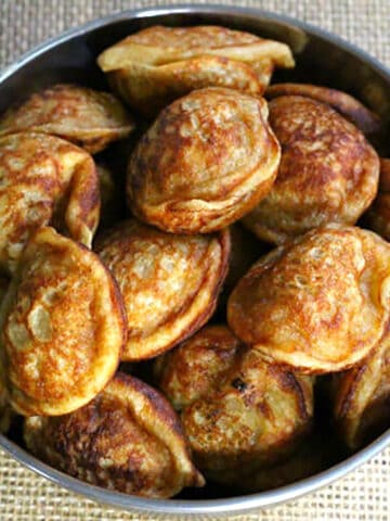 Instant sweet banana paniyaram (appam, appe, paddu) in a pan. Indian evening snack or dessert.