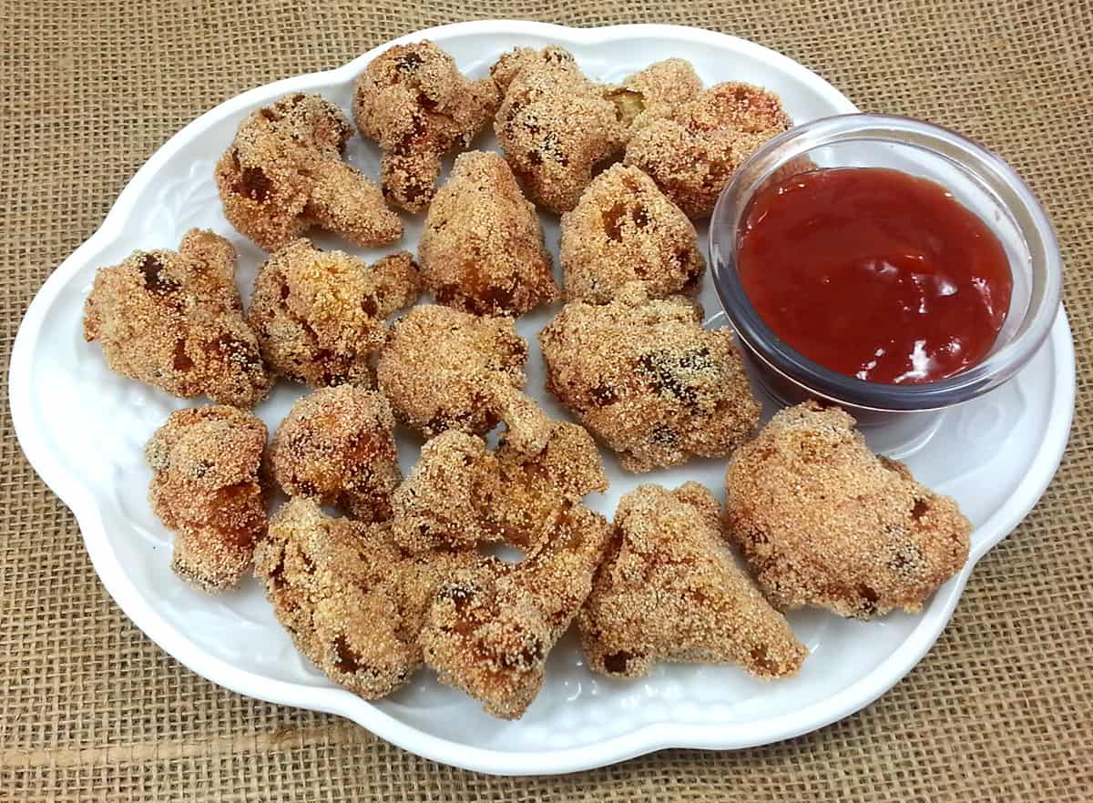 Deep fried cauliflower pieces or gobi 65 south Indian style on a plate. 
