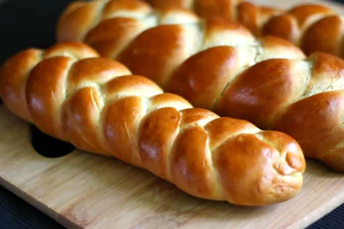 Swiss zopf (butterzopf) or braided treccia bread loaves on a serving tray.