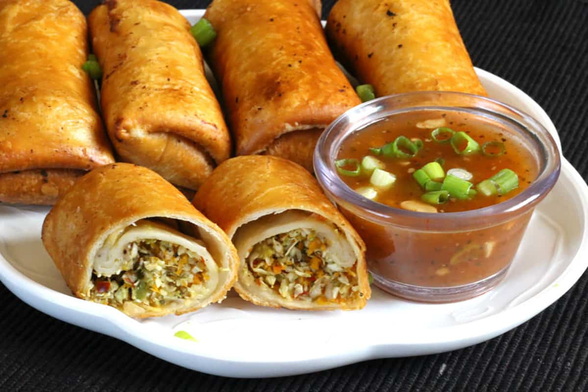 Crispy fried vegetable spring rolls served with sweet chili sauce (lumpia, thai spring rolls). 