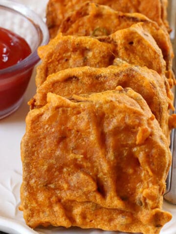best bread pakora or bread bajji served on a white plate with tomato ketchup.