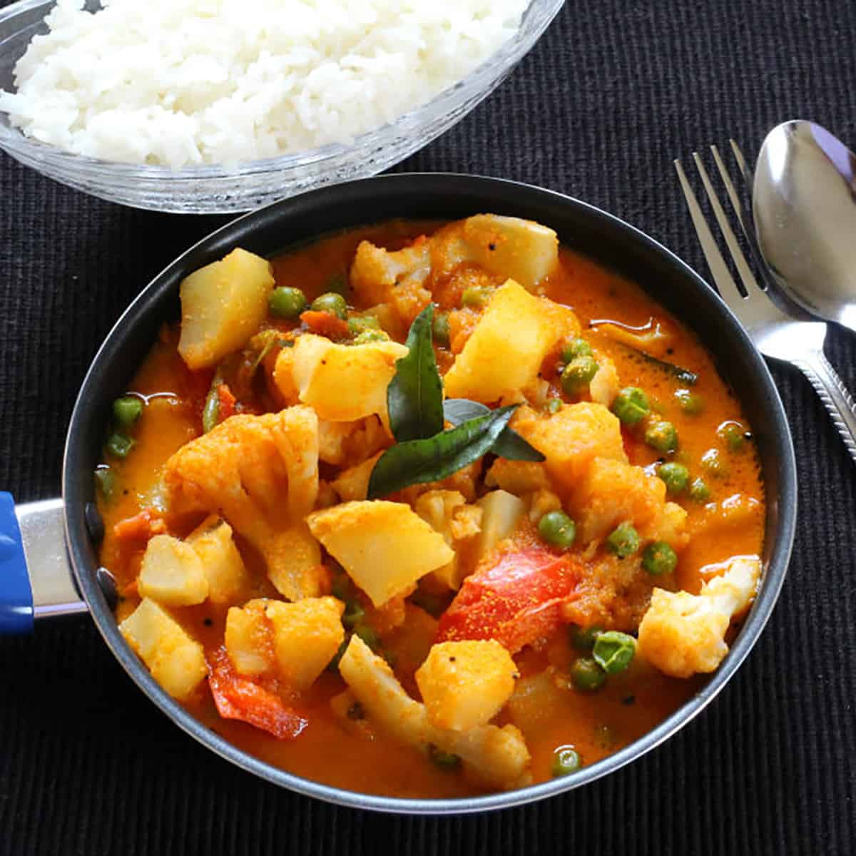 Potato curry with steamed rice for a vegetarian meal. 