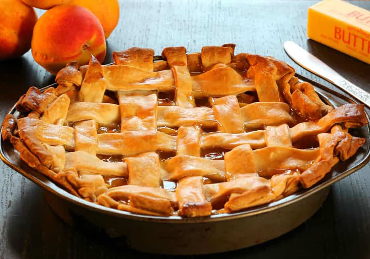 Best homemade peach pie with filling made from fresh peaches and butter flaky pie crust. 