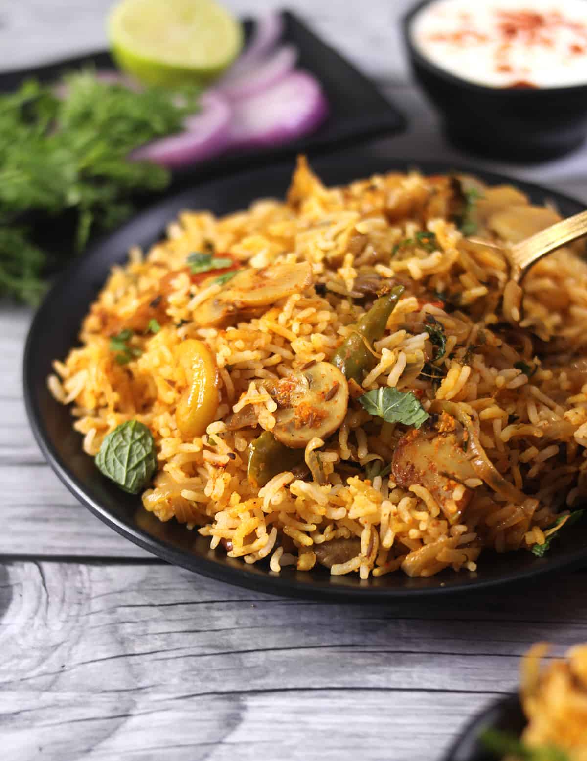 Mushroom biryani recipe (Classic vegetarian biryani) served on a plate for lunch with salad. 