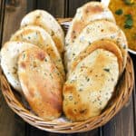 Oven baked naan bread. Flavored Indian flatbread recipe.