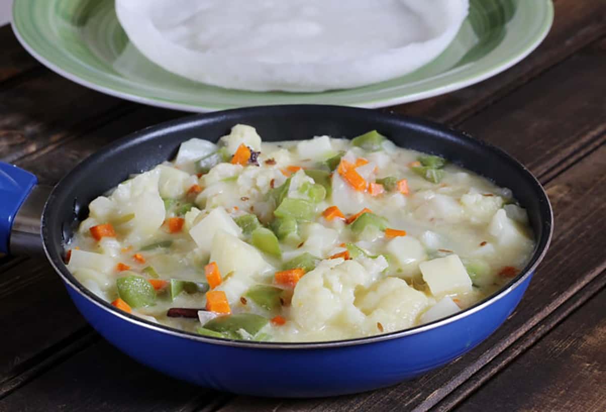 Best vegetable stew in a pan served with appam. 