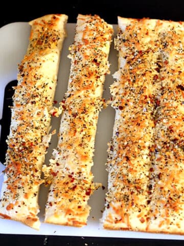 Best Garlic Breadsticks recipe, homemade from scratch with pizza dough. Easy dinner side, appetizer.