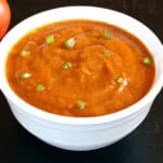 Best and Easy Tomato Chutney served in white bowl, garnished with coriander leaves.
