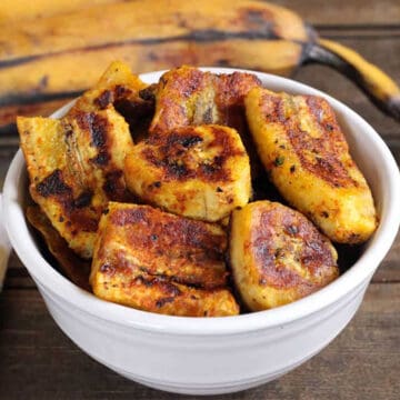 Best sweet and savory, caramelized pan fried plantains in a white bowl.