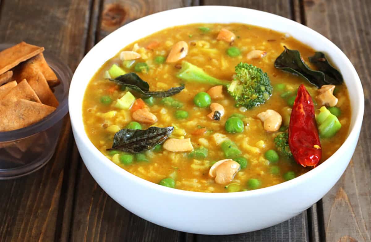 Healthy one pot bisi bele bath or khichdi in a white serving bowl. 