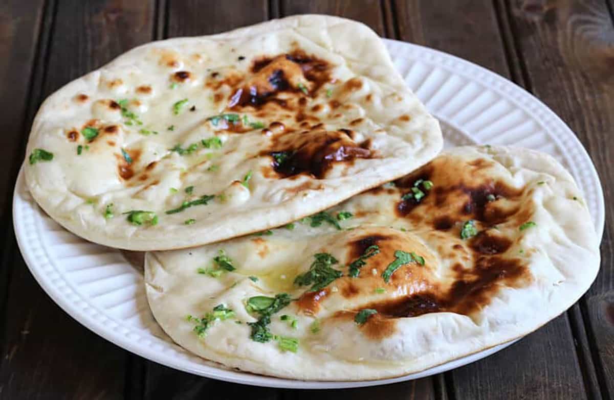 soft, pillowy, chewy naan with golden blisters, brushed with butter and herbs. 