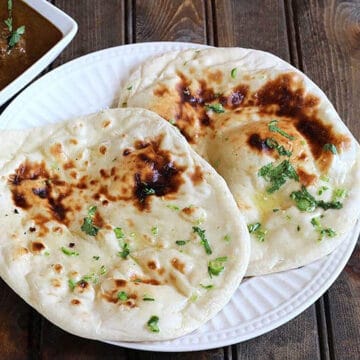 best naan bread brushed with butter, served with chicken curry.