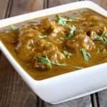 Easy and Delicious Chicken Kali Mirch served in a square white ceramic bowl.