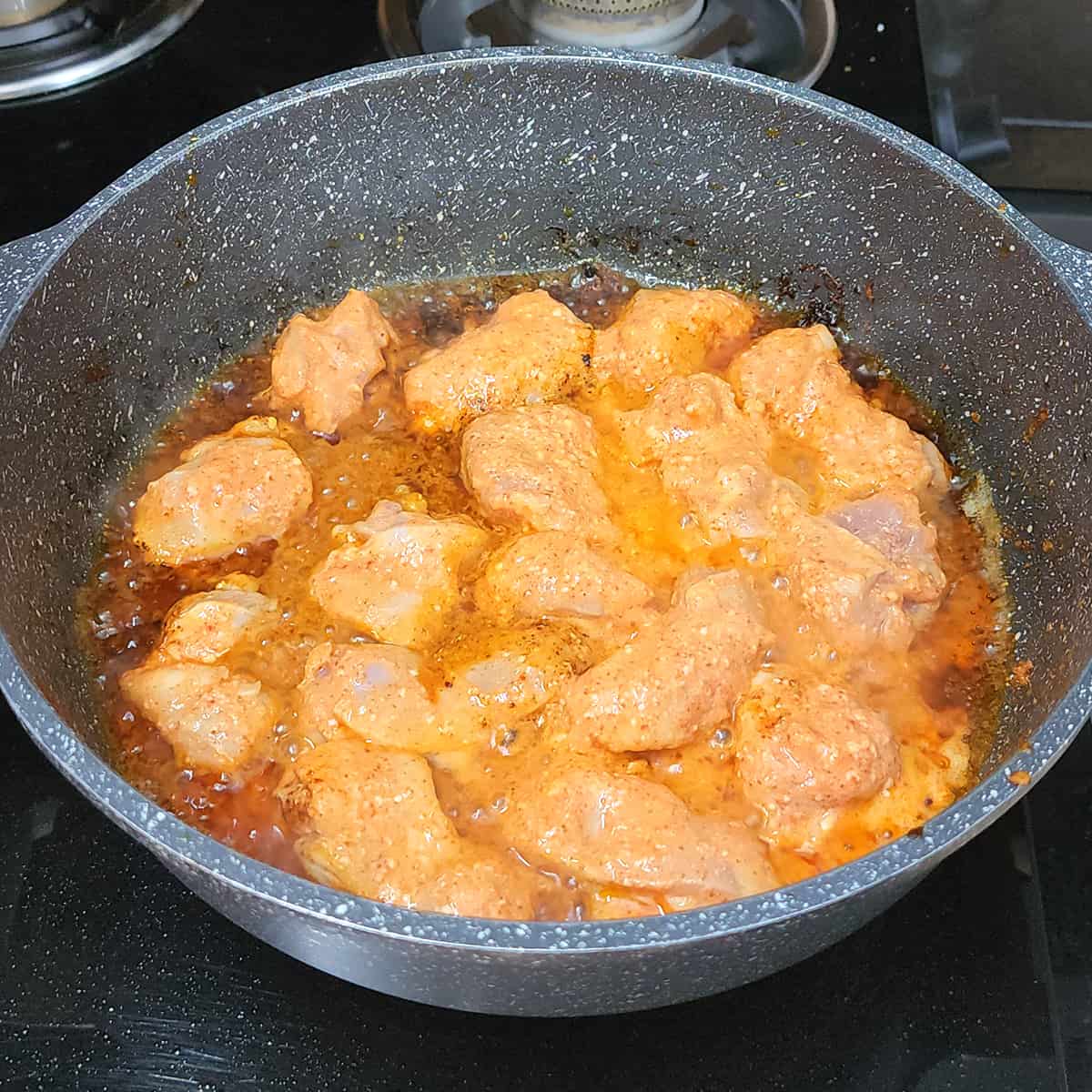 Add the marinated chicken with butter to the pan. 