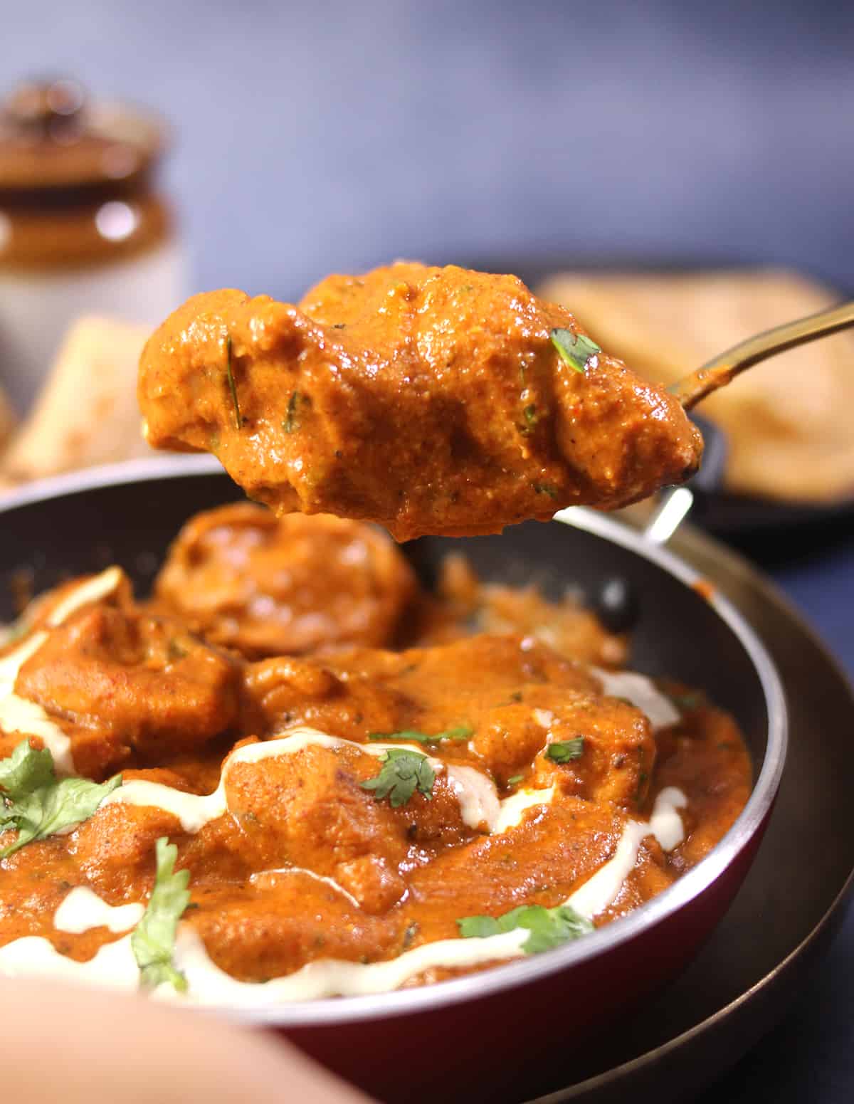 spoonful of the best creamy and authentic butter chicken curry or makhani sauce.