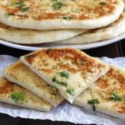 Garlic Cheese Naan Bread, naan recipe, Restaurant style naan bread, garlic naan, butter naan, paneer naan, cheese naan, stuffed naan, naan vs pita, how to make naan bread at home on cast iron pan, non stick pan, oven, no knead naan dough, easy flatbread recipes for lunch and dinner, cheese garlic stuffed bread, dinner and lunch recipes, popular Indian food recipes
