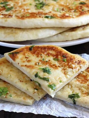 Garlic Cheese Naan Bread, naan recipe, Restaurant style naan bread, garlic naan, butter naan, paneer naan, cheese naan, stuffed naan, naan vs pita, how to make naan bread at home on cast iron pan, non stick pan, oven, no knead naan dough, easy flatbread recipes for lunch and dinner, cheese garlic stuffed bread, dinner and lunch recipes, popular Indian food recipes