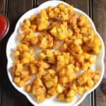Aloo pakora or Crispy potato fritters - Best snack for evening or party appetizer with potato.
