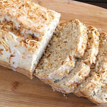 Quick and best coconut bread. Vegan coconut cake with vanilla glaze, shredded coconut flakes.