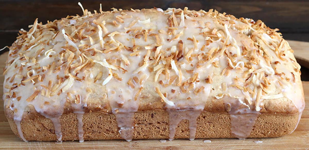 Coconut bread loaf or coconut cake made with coconut milk, oil, and unsweetened flakes. 