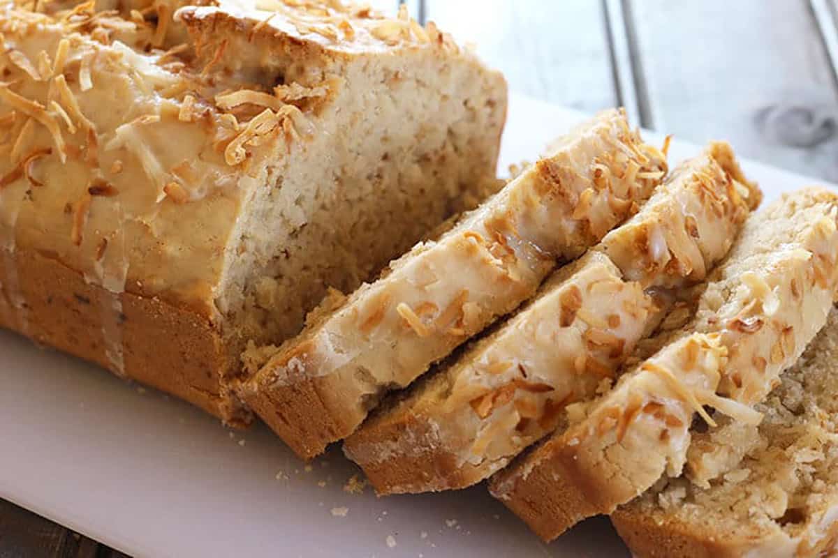 Best coconut bread loaf or vegan coconut cake with vanilla glaze and toasted coconut. 
