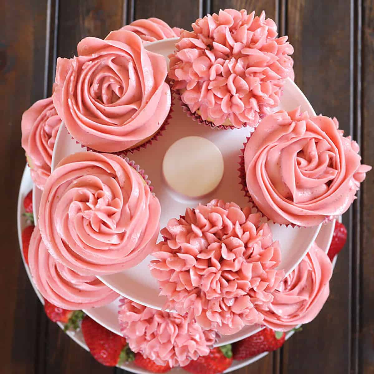 top view of beautifully decorated moist strawberry cupcakes with buttercream frosting 