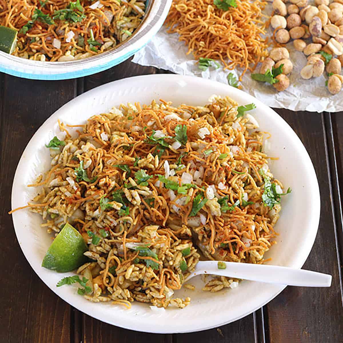 Indian bhel puri chaat, street style on a white plate. 