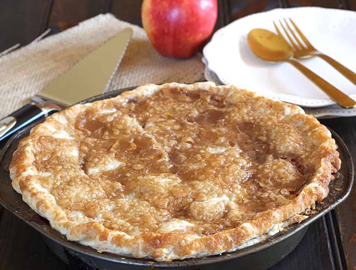 Rustic old fashioned apple blackberry pie dessert in a 9 inch pie pan. 