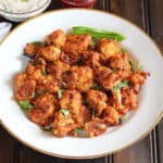 Best roasted tandoori cauliflower or gobi tikka on a serving plate with yogurt dip.