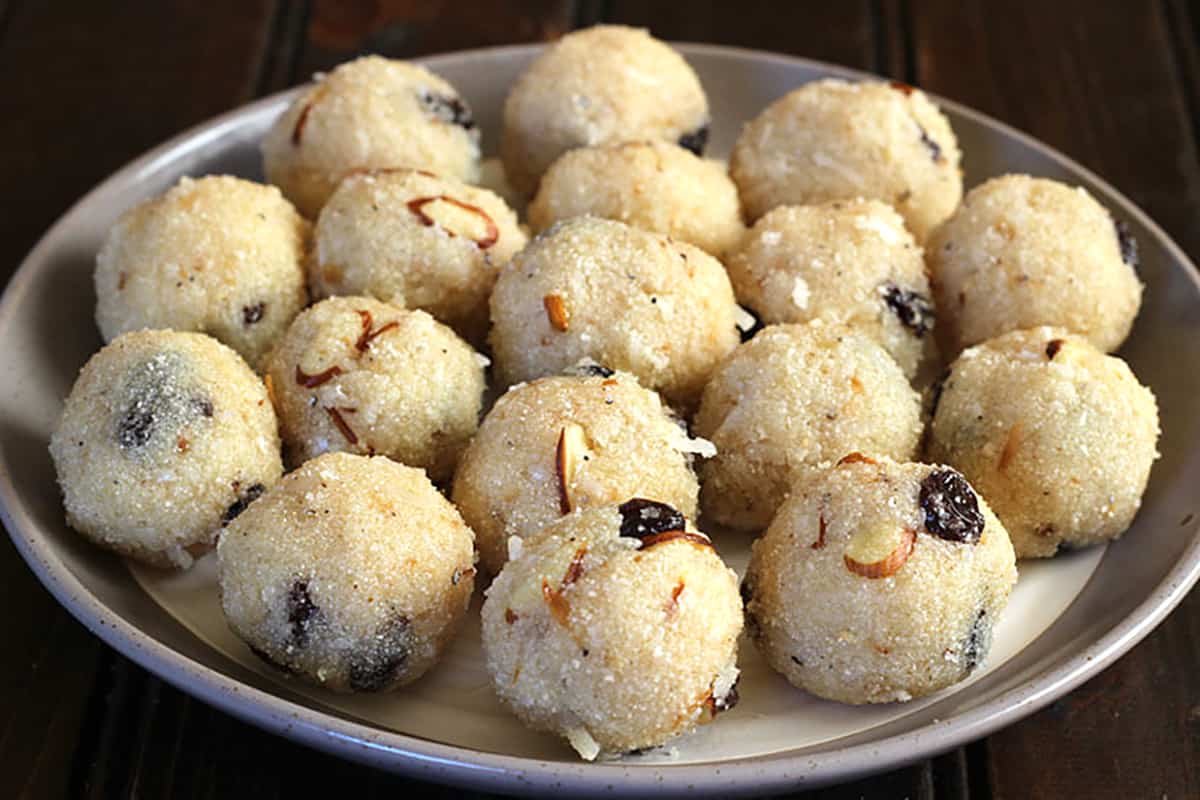 Best rava laddu or coconut sooji ladoo on a serving plate. Easy Indian sweets and desserts. 