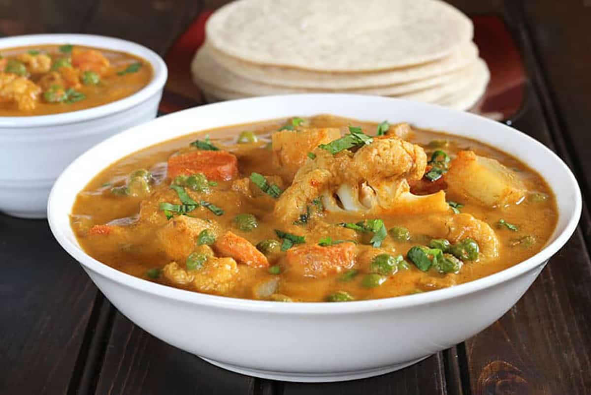 Best Indian Mixed Vegetable korma in a bowl served with dosa. 