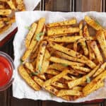healthy keto crispy jicama fries served on a plate with dipping sauce.