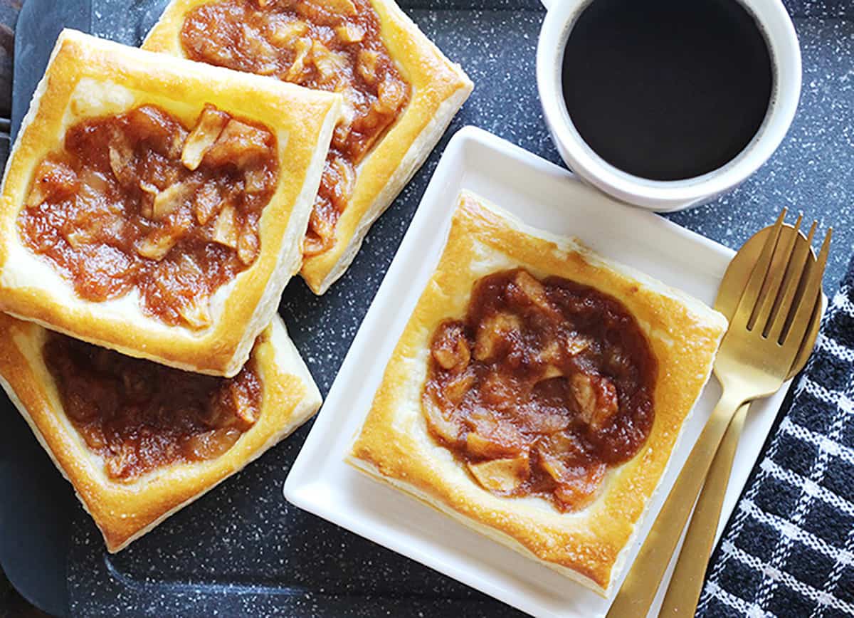 Apple tarts pastries, individual squares served with cup of coffee. 