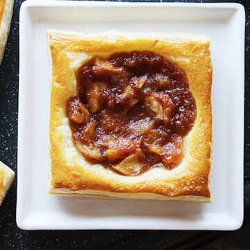 flaky and easy apple tart with puff pastry on a serving plate.