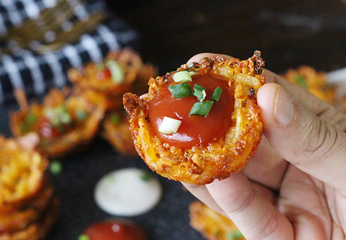 Bite size party appetizer or finger food with potatoes and tomato sauce 