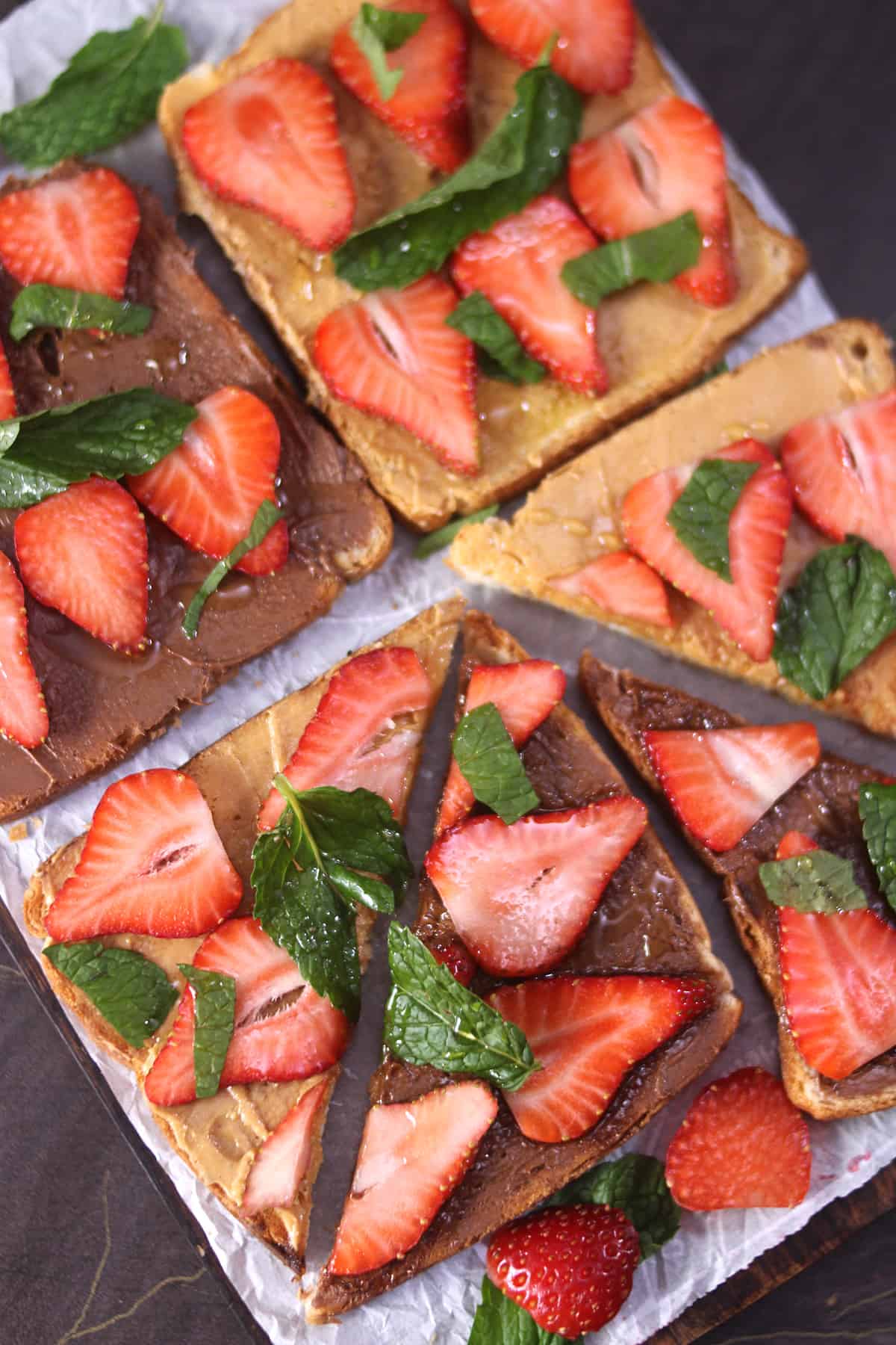 4 strawberry bread toast with peanut butter and Nutella, garnished with mint leaves.  