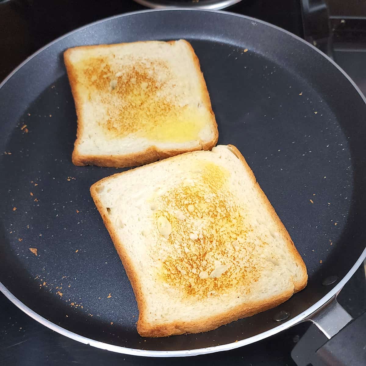 Toast the bread with butter in a black non stick skillet.