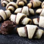 Best quick Nutella crescent rolls with tablespoon of Nutella chocolate hazelnut spread on a black plate.