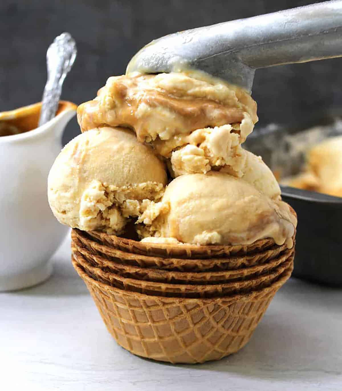 Scoops of dulce de leche caramel ice cream in waffle bowl. 