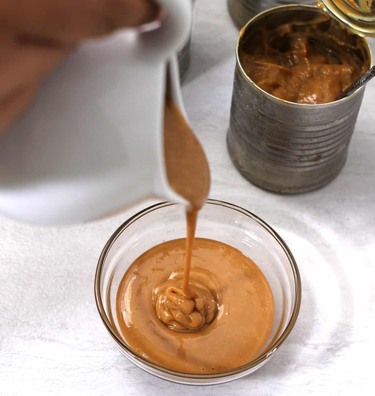 Showing the perfect, thick consistency and copper or golden brown color of homemade dulce de leche. 
