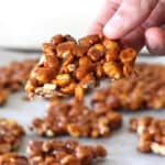 Holding best peanut brittle candy (peanut chikki) made with 3 ingredients.