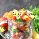 Spicy and easy fresh peach salsa in a serving glass bowl!