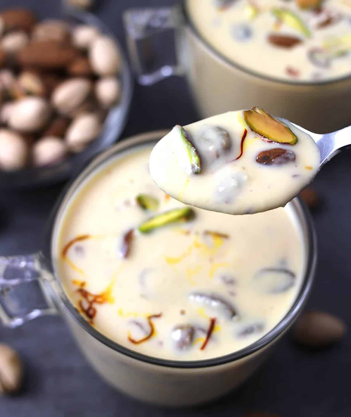 A spoonful of thick sweetened milk basundi - easy Indian milk sweet or dessert. 