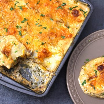 Mexican flavored Potato Au Gratin served in a brown plate. The baking pan containing freshly prepared au gratin is also in the scene.