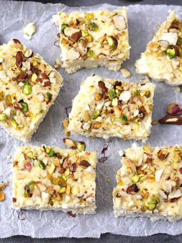 Traditional Indian kalakand sweet slices (Indian milk cake or cheesecake) garnished with nuts.