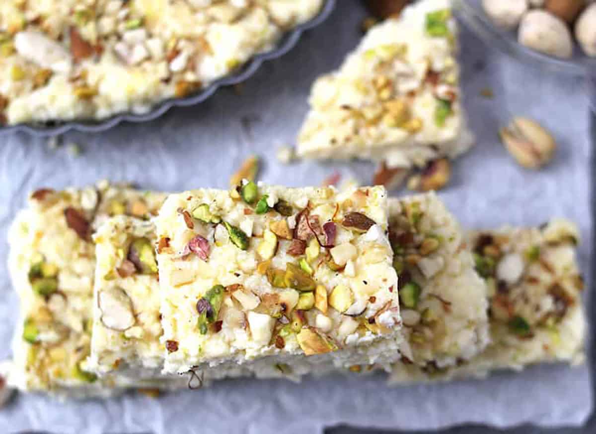Kalakand burfi sweet slices garnished with nuts prepared using paneer (chena) and condensed milk. 