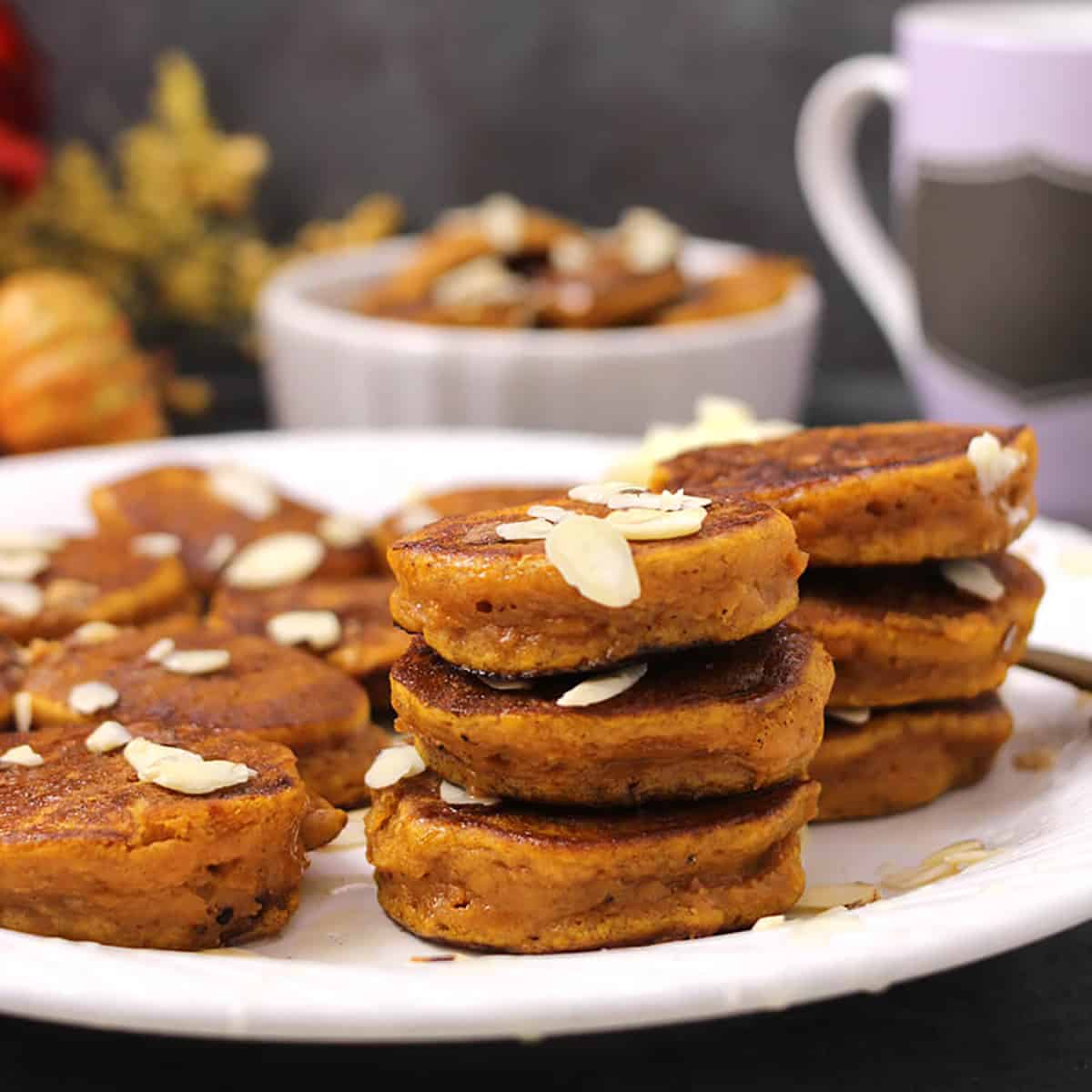 Stack of fluffy pumpkin pancakes recipe. Fall and holiday breakfast. 