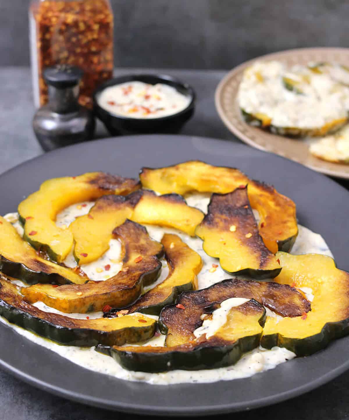 Simple and easy appetizer or side dish with acorn squash served with garlic cream sauce. 