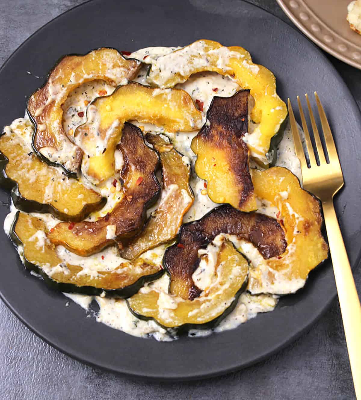 Roasted acorn squash slices served with homemade garlic cream sauce. 